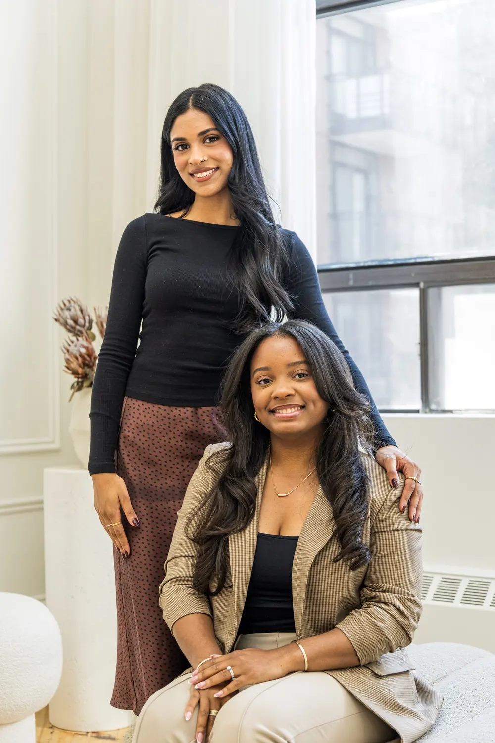 Two team members smiling together in the studio