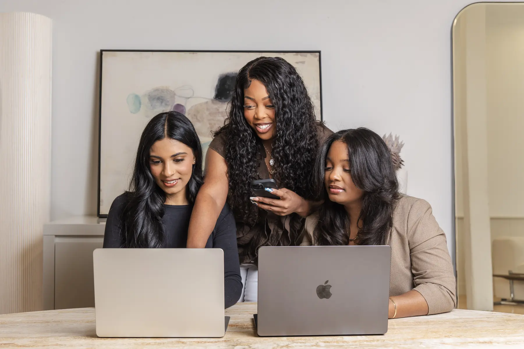 Three members of the team working together at their laptops