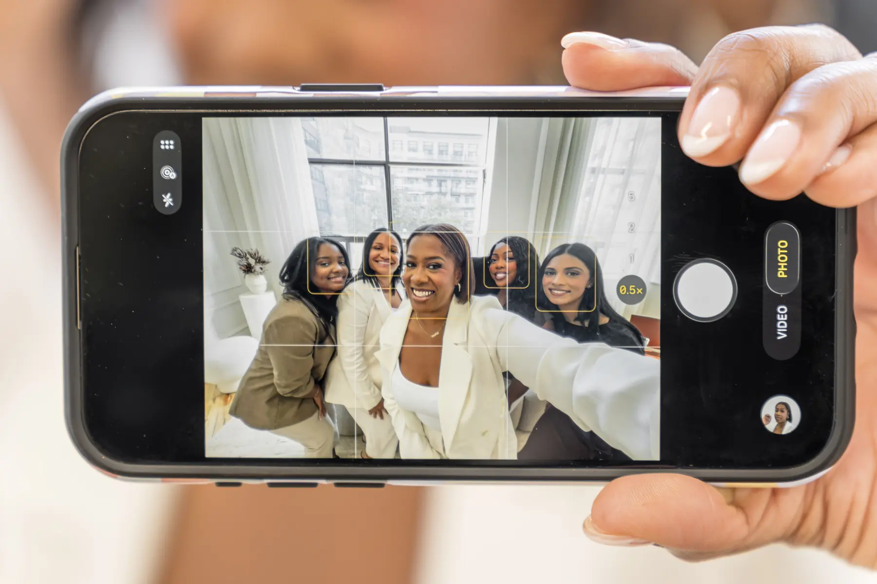 A phone taking a photo of the team together